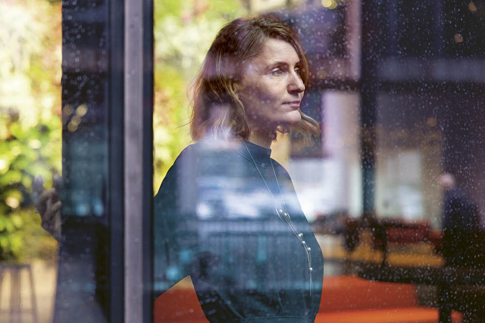 Portrait of a women looking out of a window. 