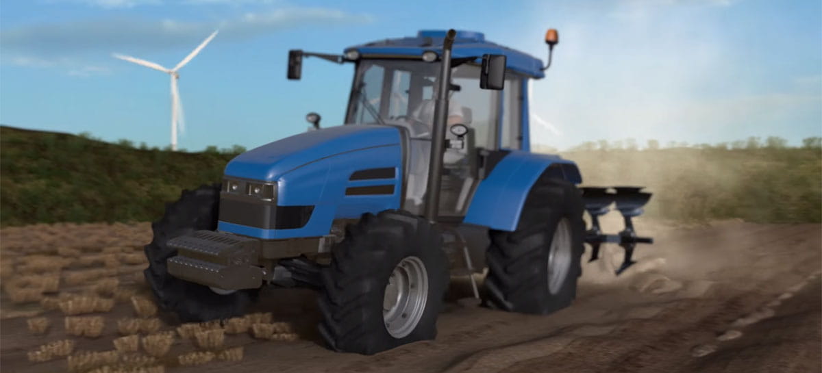 Tractor on the field and in the background you can see a wind turbine